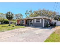 Charming single-story home featuring a well-maintained lawn and inviting curb appeal on a sunny day at 27 Park Ave, Tarpon Springs, FL 34689