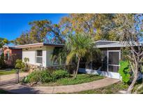 Charming single-story home with a well-maintained lawn and a cozy screened-in porch at 3501 Beechwood N Ter, Pinellas Park, FL 33781