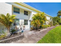 Two-story townhouse with a well-maintained lawn and tropical landscaping at 4215 La Sorrento Ct, Tampa, FL 33611