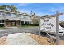 Exterior view of the Park View Condo building with a stone facade and well-maintained landscaping at 800 71St N Ave # 8, St Petersburg, FL 33702