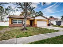 Charming single-story home with a manicured lawn, attached garage, and neutral paint scheme, blending comfort and curb appeal at 6445 109Th N Ave, Pinellas Park, FL 33782