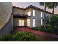 A two-story condo building with an exterior stairwell and red walkway at 7200 Ulmerton Rd # B4, Largo, FL 33771