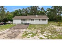 Charming single-story home with a welcoming front porch, a driveway, and a well-maintained yard at 12651 Tinley Rd, New Port Richey, FL 34654