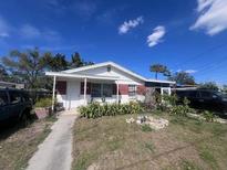 Charming single-story home featuring a welcoming front porch and well-maintained yard at 1422 E Chilkoot Ave, Tampa, FL 33612