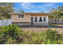 Charming one-story home with a large front window and stone accents at 4716 Gazania St, New Port Richey, FL 34652
