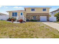 Charming two-story home with a stone facade, front yard landscaping, and an attached garage at 8517 43Rd W Ave, Bradenton, FL 34209