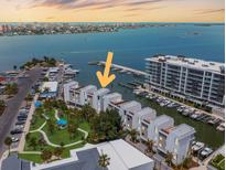 Stunning aerial view of waterfront condos, featuring a marina, and city skyline at 870 N Osceola Ave, Clearwater, FL 33755