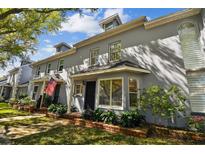 Street view of the townhome featuring beautiful landscaping and a well-maintained lawn at 2515 S Ysabella Ave, Tampa, FL 33629