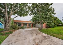 Charming brick home with mature trees and a long driveway at 3111 Teal Ter, Safety Harbor, FL 34695