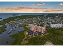 Panoramic aerial view of waterfront condominium complex at sunset showing docks and gorgeous water views at 4516 Seagull Dr # 614, New Port Richey, FL 34652