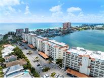 Breathtaking aerial view of beachfront condos, sparkling ocean, and the intercoastal waterway under a clear sky at 17735 Gulf Blvd # 204, Redington Shores, FL 33708