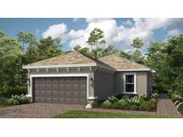 Charming one-story home with a brick driveway, two-car garage, manicured lawn, and professionally landscaped at 29463 Velletri Ln, Wesley Chapel, FL 33543