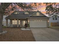 Charming single-Gathering home featuring a spacious front porch and well-manicured lawn at dusk at 4710 69Th E Ct, Palmetto, FL 34221