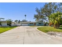 Charming single-story home with a well-manicured lawn and long driveway at 5050 Venetian Ne Blvd, St Petersburg, FL 33703