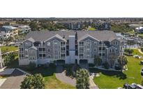 Lovely condo building featuring a well-maintained green lawn, ample parking, and boat docks at 5722 Biscayne Ct # 308, New Port Richey, FL 34652
