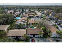 An aerial view of the multi-Gathering property surrounded by mature landscaping, parking areas, and a community pool at 8640 Tahoe Ct # 16, Tampa, FL 33614