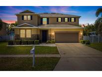 Charming two-story home with well-manicured lawn, tasteful landscaping, and a two-car garage at 5909 Canton S St, St Petersburg, FL 33712