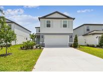 Charming two-story home features a well-manicured lawn and a spacious two-car garage at 10537 Hidden Banks Gln, Parrish, FL 34219