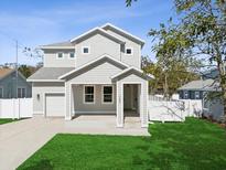 Charming two-story home with a well-manicured front lawn and a light-colored exterior at 1753 25Th N Ave, St Petersburg, FL 33713