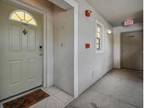 Inviting front entryway with a secure door featuring a decorative door knocker and an adjacent staircase at 21103 Patio View Ct # 3305, Lutz, FL 33558