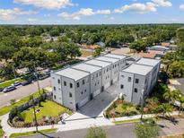 Modern townhome complex featuring clean lines and a neutral color palette in a well-landscaped neighborhood at 2205 16Th N St, St Petersburg, FL 33704