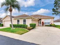 Charming single-story home featuring a well-manicured lawn, mature landscaping and inviting curb appeal at 10138 Mowry Ln, Tampa, FL 33625