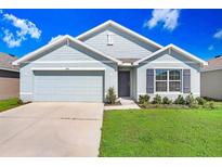 Charming single-Gathering home with a well-maintained lawn and attached two-car garage at 1108 Tidal Rock Ave, Ruskin, FL 33570