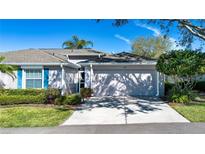 Charming single-story home with attached garage, well-maintained landscaping, and a welcoming entryway at 1122 Corinth Greens Dr, Sun City Center, FL 33573