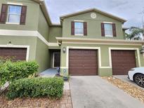 Inviting townhome featuring an attached garage, neutral paint scheme, and well-maintained landscaping at 2807 Lantern Hill Ave, Brandon, FL 33511