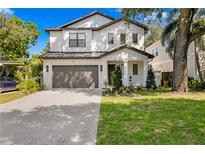 Charming two-story home featuring a well-maintained lawn, a two-car garage, and a welcoming front entrance at 3618 W Royal Palm Cir, Tampa, FL 33629