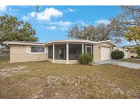 Charming single-story home with a screened porch and attached one-car garage at 5317 Tammy Ln, Holiday, FL 34690