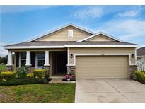 Charming single-Gathering home featuring a well-manicured lawn and a two-car garage, creating a welcoming curb appeal at 8438 Wheat Stone Dr, Zephyrhills, FL 33540