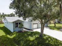 Charming single-story home with well-maintained lawn, attached two-car garage, and mature landscaping at 14334 Channel Dr, Largo, FL 33774