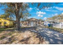 Charming single-story home featuring a well-maintained front yard and a long driveway with ample parking space at 15530 Morgan St, Clearwater, FL 33760