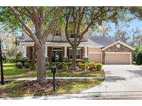 Charming two-story home featuring stone accents, manicured landscaping and a three car garage at 15912 Ternglade Dr, Lithia, FL 33547