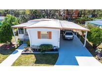 Charming single-story home with a covered parking area and well-maintained landscaping at 585 Sky Harbor Dr # 416, Clearwater, FL 33759