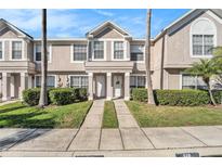 Charming townhome featuring a well-manicured lawn and inviting front entrance at 630 Kensington Lake Cir, Brandon, FL 33511