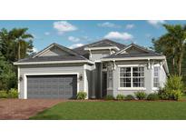 Charming single-story home with a two-car garage, manicured lawn, and beautifully landscaped front yard at 12866 Tulum Loop, Venice, FL 34293