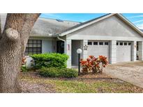 Charming single-story home featuring a well-maintained lawn and attached two-car garage at 1547 Rebecca Ln # 505, Dunedin, FL 34698