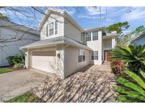 Charming two-story home with lush landscaping, brick entryway and attached two car garage at 16010 Gatwick Ct, Tampa, FL 33647