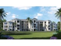 Beautiful three-story building with patios, lush landscaping, and a well-manicured lawn at 17560 Opal Sand Dr # 201, Venice, FL 34293