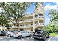 Apartment building featuring a distinctive turret design and well-maintained landscaping at 2351 Irish Ln # 43, Clearwater, FL 33763