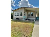 Charming single-story home with a well-maintained lawn and covered parking at 34344 Timberland Blvd, Wesley Chapel, FL 33543