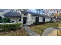 Charming single-story home with manicured front yard and welcoming entryway gate at 3859 Pheasant Ct, Palm Harbor, FL 34685