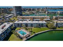 Stunning aerial view of the condominium, pool, and waterfront, showcasing the building's unique location at 7405 Bay Island S Dr # 220, South Pasadena, FL 33707