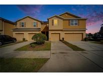 Inviting townhome exterior showcasing attached garages and well-maintained landscaping in a desirable neighborhood at 8842 Turnstone Haven Pl, Tampa, FL 33619