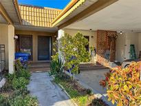 Inviting front entrance with lush landscaping and covered parking at 9221 Repondo Pl, New Port Richey, FL 34655
