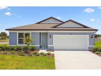 Charming single-story home featuring a two-car garage, manicured lawn, and welcoming curb appeal at 1226 Mumford Ct, Zephyrhills, FL 33540
