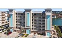 Multi-story condo building showcasing a modern design with waterfront views and ample parking spaces at 125 Island Way # 404, Clearwater Beach, FL 33767