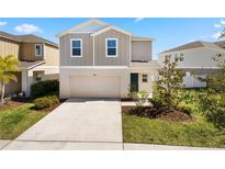 Charming two-story home with a two-car garage and well-maintained lawn in a desirable neighborhood at 12846 Tannencrest Dr, Riverview, FL 33579